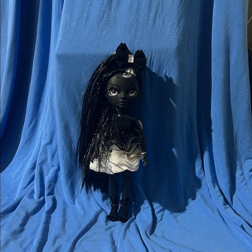 Elegant Black and White Doll with Bow
